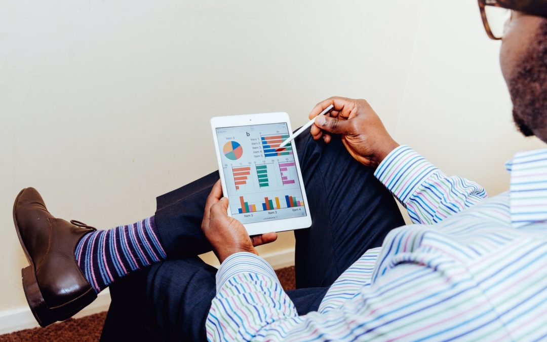 person sitting on chair holding iPad